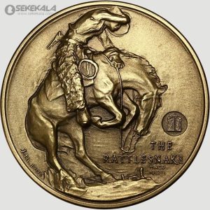 این مدال یادبود هنری، اثری از فردریک رمنگتون، نقاش و مجسمه‌ساز برجسته آمریکایی، است که در سال ۱۹۰۵ ضرب شده است. طراحی آن یک سوارکار را در حال رام کردن اسبی وحشی نشان می‌دهد که با مار زنگی (Rattlesnake) درگیر است، نمادی از زندگی پرماجرا و خشن غرب وحشی. این مدال با کیفیت بالا، به‌عنوان یکی از شاهکارهای رمنگتون، یادگاری ارزشمند برای مجموعه‌داران و علاقه‌مندان به هنر و تاریخ غرب آمریکا محسوب می‌شود. متن حکاکی‌شده "THE RATTLESNAKE" و امضای "J.E. Fraser 1905" اصالت و تاریخچه آن را تأیید می‌کند.
